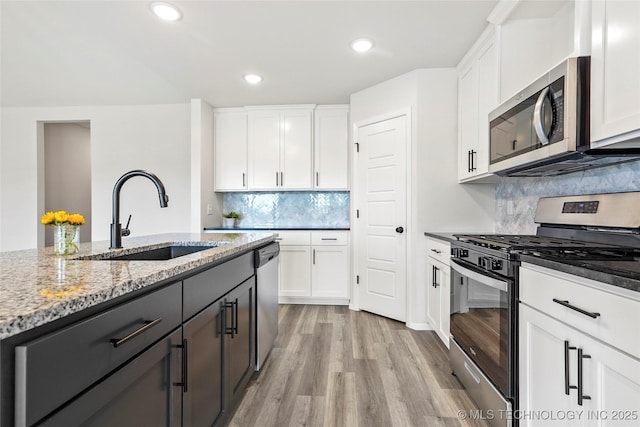 13119 S 72nd E Pl, Bixby, OK 74008 - kitchen with light stone countertops, light wood-style floors, white cabinetry, a sink, and appliances with stainless steel finishes