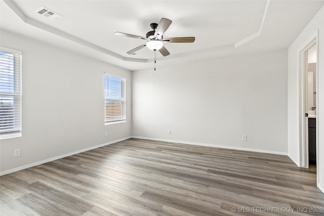 13119 S 72nd E Pl, Bixby, OK 74008 - unfurnished room with a raised ceiling, a ceiling fan, wood finished floors, and visible vents