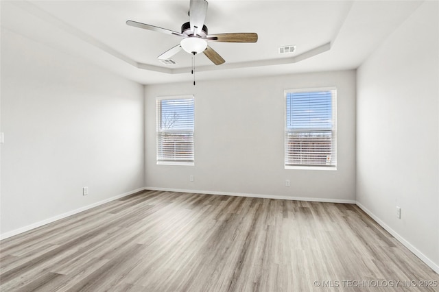 13119 S 72nd E Pl, Bixby, OK 74008 - unfurnished room with a ceiling fan, visible vents, light wood-type flooring, a raised ceiling, and baseboards