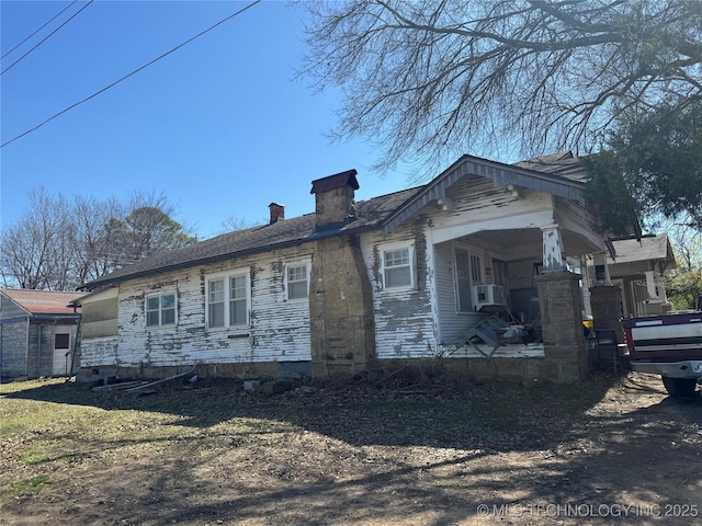 view of property exterior featuring a chimney and cooling unit