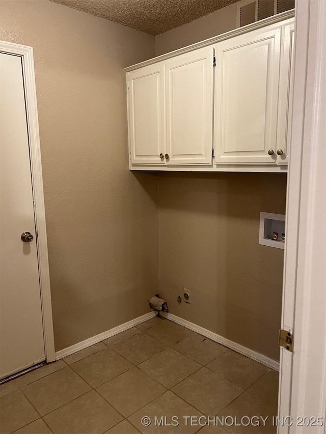 laundry area with washer hookup, baseboards, a textured ceiling, cabinet space, and hookup for a gas dryer