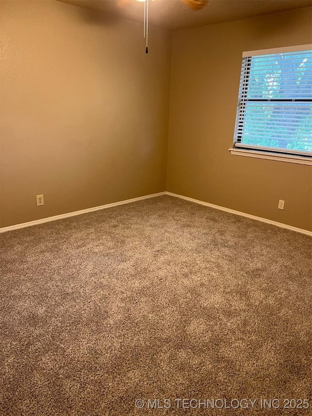 unfurnished room with carpet flooring, baseboards, and ceiling fan
