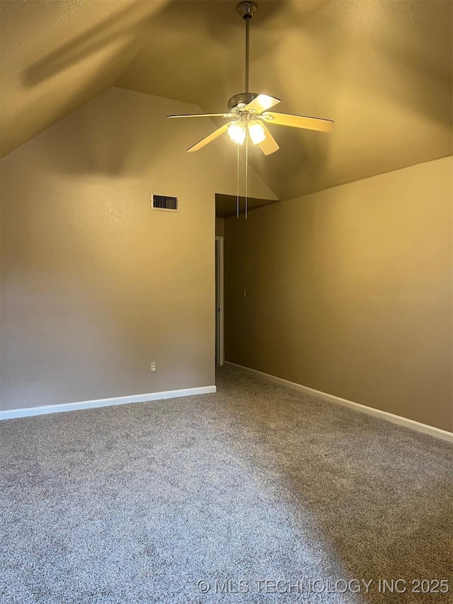 spare room featuring visible vents, ceiling fan, lofted ceiling, and carpet flooring
