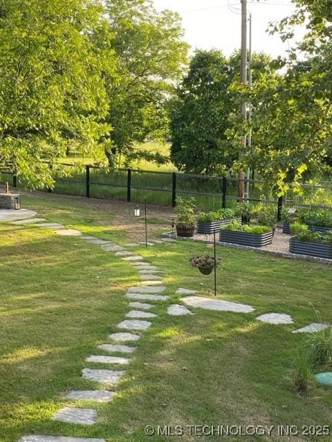 8700 S Union Ave, Tulsa, OK 74132 - view of property's community with a vegetable garden, fence, and a yard