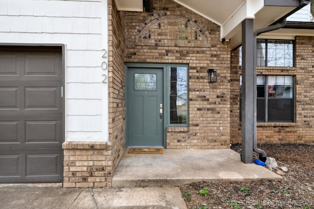 property entrance featuring brick siding