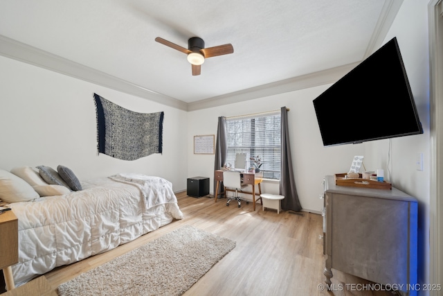 bedroom featuring light wood-type flooring, ornamental molding, and ceiling fan
