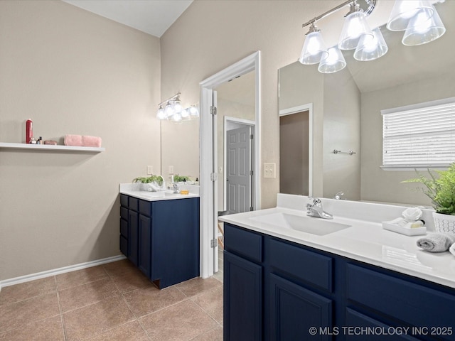 full bath with vanity, baseboards, and tile patterned flooring