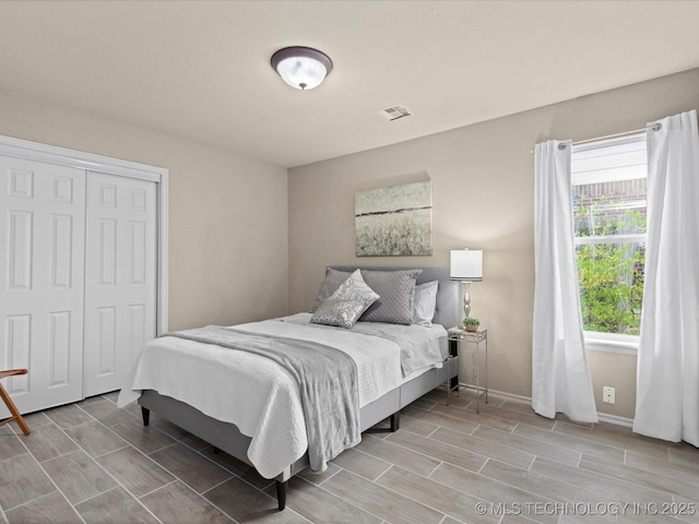 3017 Lincoln Rd, Bartlesville, OK 74006 - bedroom with wood tiled floors, baseboards, and a closet