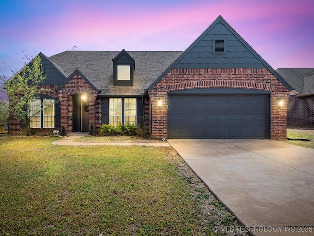 3017 Lincoln Rd, Bartlesville, OK 74006 - view of front of home with brick siding, driveway, a yard, and roof with shingles