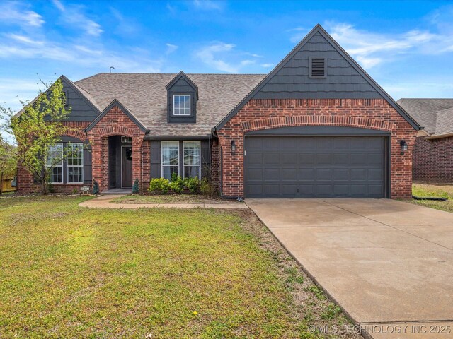 3017 Lincoln Rd, Bartlesville, OK 74006 - tudor home with brick siding, a front yard, driveway, and roof with shingles