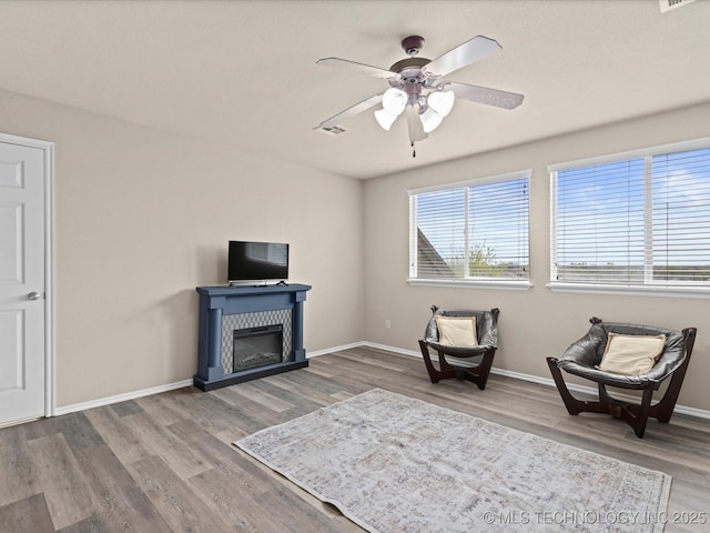sitting room featuring visible vents, baseboards, a ceiling fan, and wood finished floors