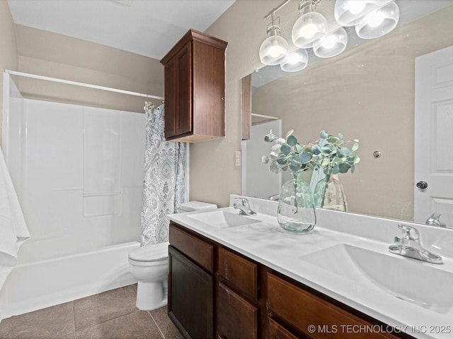 bathroom featuring a sink, tile patterned floors, toilet, and double vanity