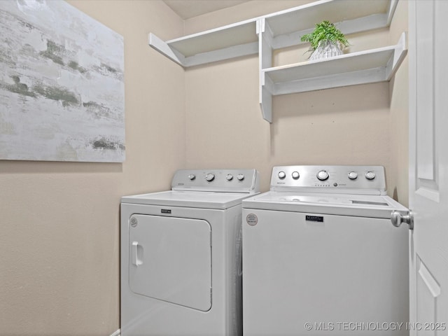 washroom with washing machine and dryer and laundry area
