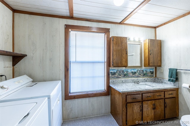 703 N Sioux Ave, Claremore, OK 74017 - washroom with independent washer and dryer, wood ceiling, and wood walls