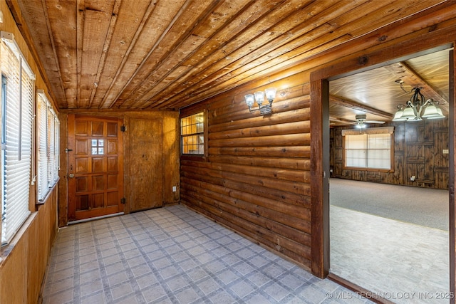 703 N Sioux Ave, Claremore, OK 74017 - unfurnished room featuring wooden ceiling, rustic walls, tile patterned floors, wooden walls, and ceiling fan
