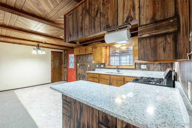 703 N Sioux Ave, Claremore, OK 74017 - kitchen featuring range, wooden ceiling, light stone counters, a chandelier, and brown cabinets