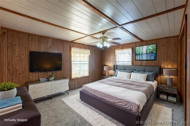 703 N Sioux Ave, Claremore, OK 74017 - bedroom with carpet, wooden ceiling, and wood walls