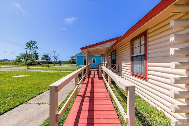 703 N Sioux Ave, Claremore, OK 74017 - wooden deck featuring a lawn