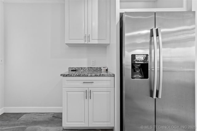5729 E 24th Pl S, Tulsa, OK 74114 - kitchen featuring baseboards, white cabinetry, stone counters, and stainless steel fridge
