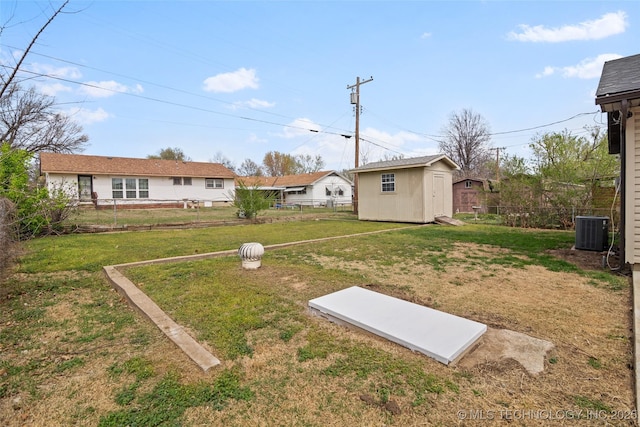 5729 E 24th Pl S, Tulsa, OK 74114 - view of yard with an outbuilding, fence, central AC, and a shed