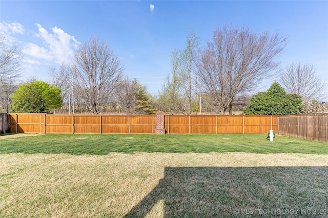 view of yard with a fenced backyard