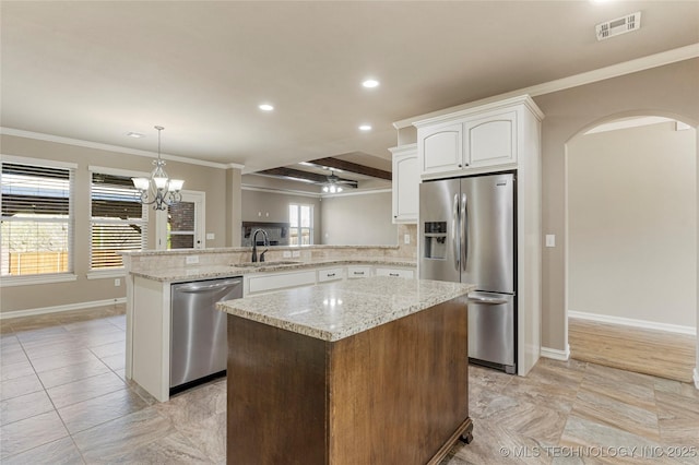 kitchen with a sink, appliances with stainless steel finishes, visible vents, arched walkways, and a peninsula