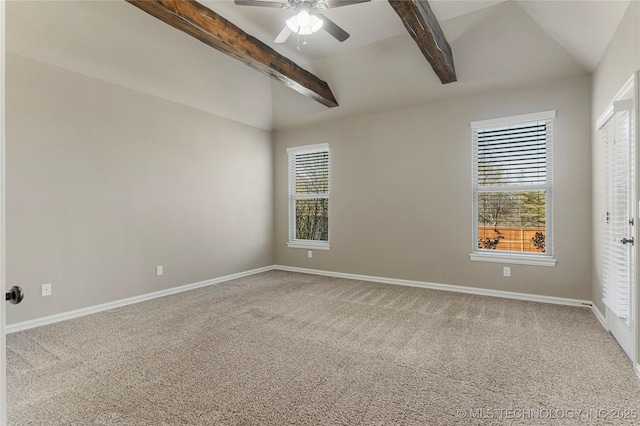 carpeted spare room with lofted ceiling with beams, a ceiling fan, and baseboards
