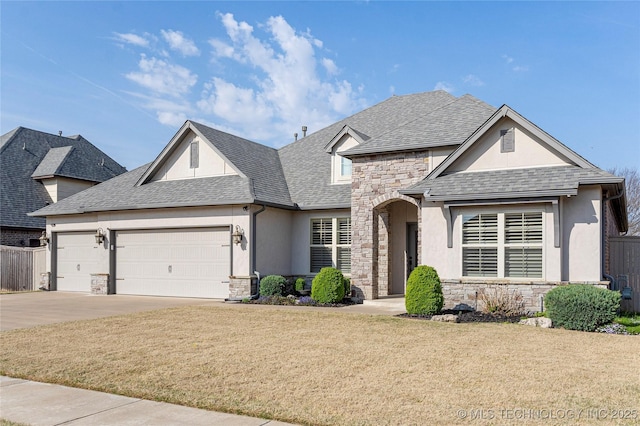 view of front of house with an attached garage, stone siding, stucco siding, and a shingled roof