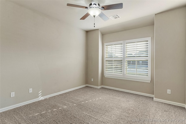 spare room featuring baseboards, visible vents, a ceiling fan, and carpet floors