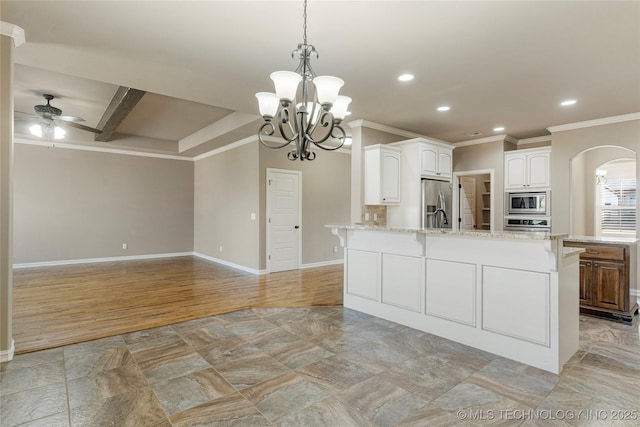 kitchen featuring recessed lighting, stainless steel appliances, ornamental molding, arched walkways, and ceiling fan with notable chandelier