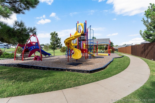 communal playground with fence and a lawn