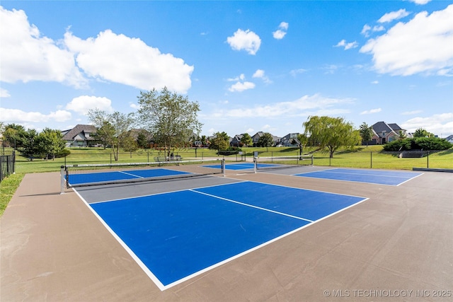 view of tennis court featuring fence, a lawn, and community basketball court