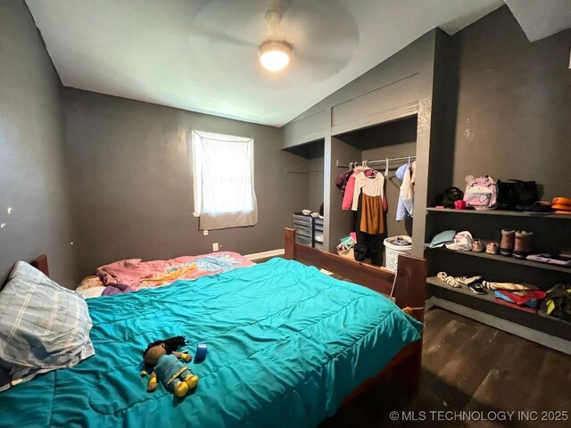 bedroom featuring vaulted ceiling and wood finished floors
