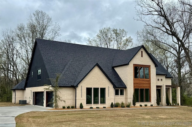30303 E 59th St S, Broken Arrow, OK 74014 - view of front facade with driveway, roof with shingles, a garage, and a front lawn