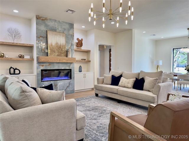 30303 E 59th St S, Broken Arrow, OK 74014 - living room with wood finished floors, a chandelier, a tile fireplace, recessed lighting, and built in shelves