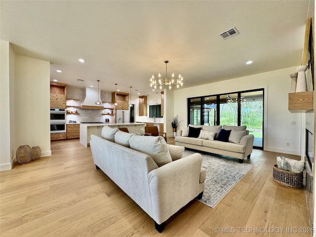 30303 E 59th St S, Broken Arrow, OK 74014 - living room featuring a chandelier, recessed lighting, light wood-style flooring, and a fireplace