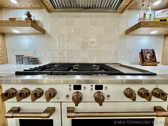 30303 E 59th St S, Broken Arrow, OK 74014 - kitchen view of range with two ovens, extractor fan, tasteful backsplash, and light countertops