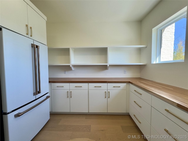 30303 E 59th St S, Broken Arrow, OK 74014 - kitchen with freestanding refrigerator, wood counters, open shelves, white cabinetry, and light wood-style floors