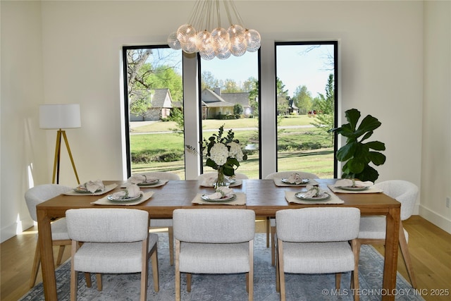 30303 E 59th St S, Broken Arrow, OK 74014 - dining area with a chandelier and wood finished floors