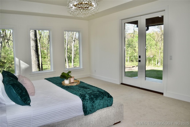 30303 E 59th St S, Broken Arrow, OK 74014 - carpeted bedroom featuring access to outside, french doors, and a chandelier