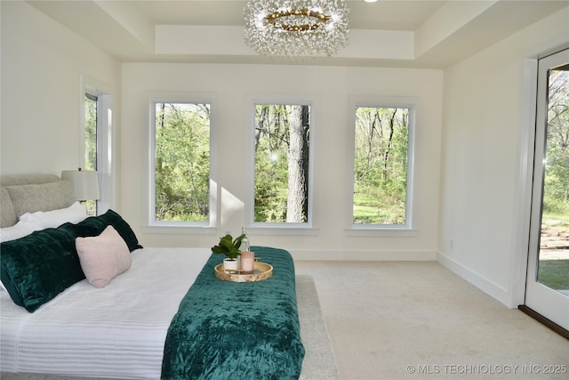 30303 E 59th St S, Broken Arrow, OK 74014 - carpeted bedroom featuring multiple windows, a raised ceiling, and a chandelier