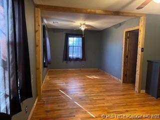 unfurnished bedroom with wood finished floors and a ceiling fan