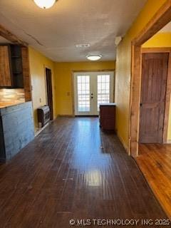 unfurnished living room featuring dark wood-style floors