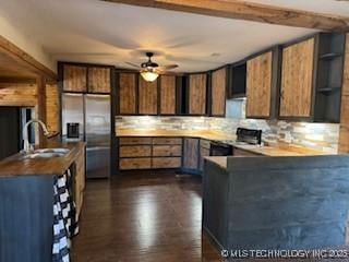 kitchen featuring stove, stainless steel refrigerator with ice dispenser, open shelves, a ceiling fan, and a peninsula
