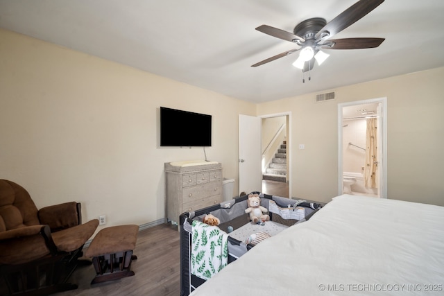 2936 E 84th St Unit 38, Tulsa, OK 74137 - bedroom featuring wood finished floors, ensuite bathroom, ceiling fan, and baseboards