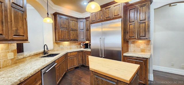870 Cherry Springs Dr, Tahlequah, OK 74464 - kitchen with stainless steel appliances, arched walkways, decorative backsplash, butcher block counters, and ornamental molding