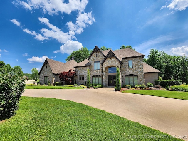 870 Cherry Springs Dr, Tahlequah, OK 74464 - french country style house featuring stone siding and a front lawn