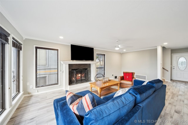 42 Diamond Head Dr Unit 42, Sand Springs, OK 74063 - living room with crown molding, a lit fireplace, recessed lighting, ceiling fan, and light wood-style floors