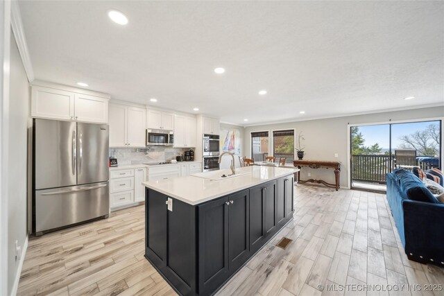 42 Diamond Head Dr Unit 42, Sand Springs, OK 74063 - kitchen with stainless steel appliances, white cabinetry, crown molding, light wood-style floors, and light countertops