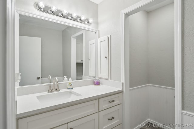 42 Diamond Head Dr Unit 42, Sand Springs, OK 74063 - bathroom featuring vanity and a wainscoted wall